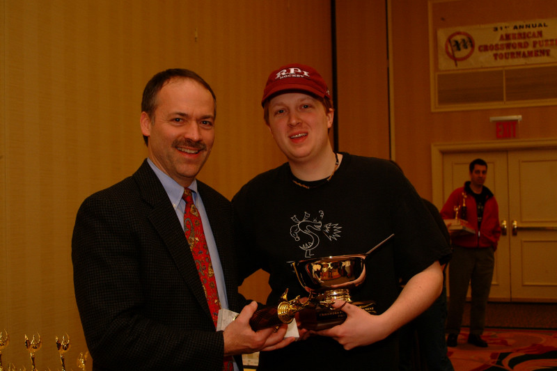 Will Shortz giving 1st prize trophy to Tyler Hinman